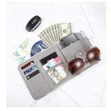 Professional driver using car visor organizer for business cards documents and essentials